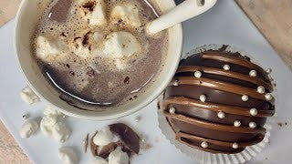 Chocolate bombs filled with marshmallows and biscuits
